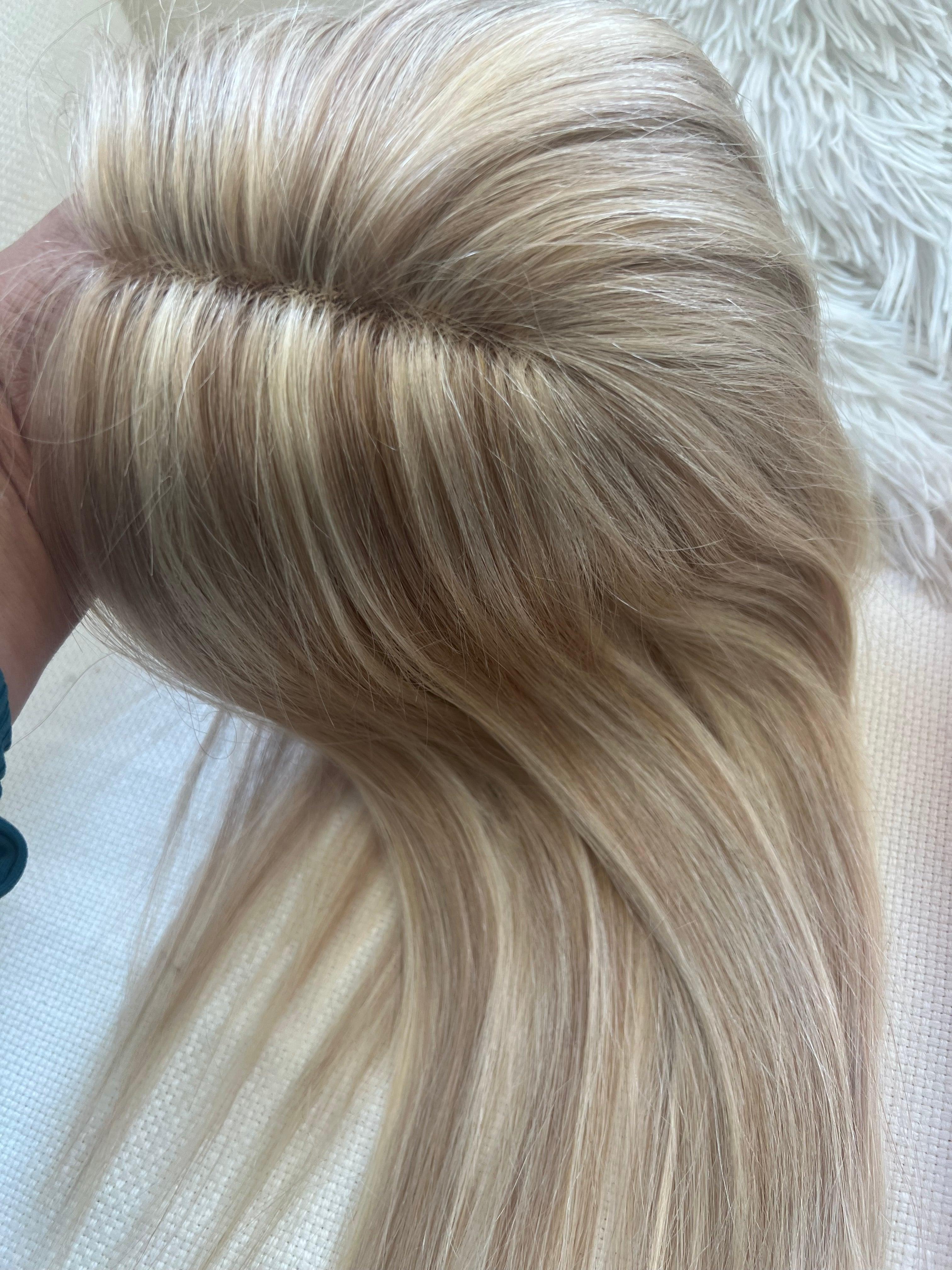 Bleach blonde hair with darker highlights